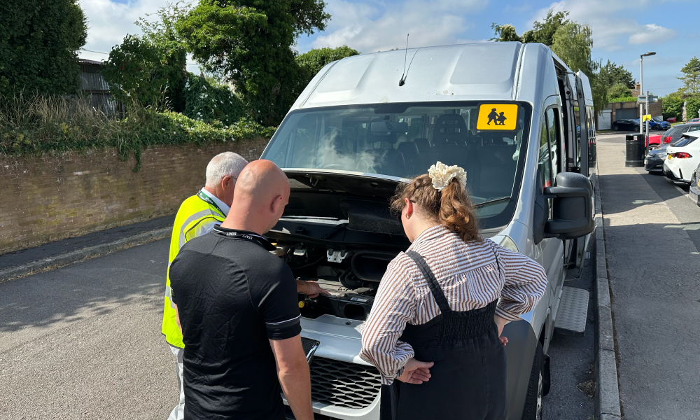 Midas minibus diver training - instructor and trainees inspect the minibus engine